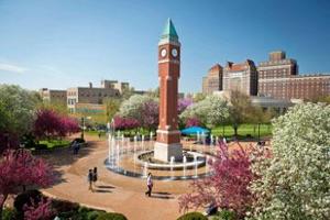 Image of clocktower with fountains on and students walking about