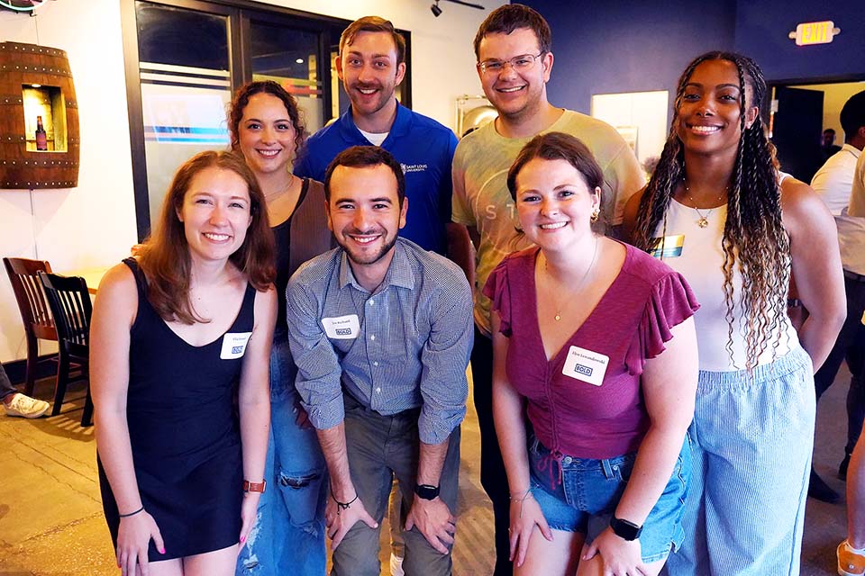 BOLD members pose for a photo at a happy hour
