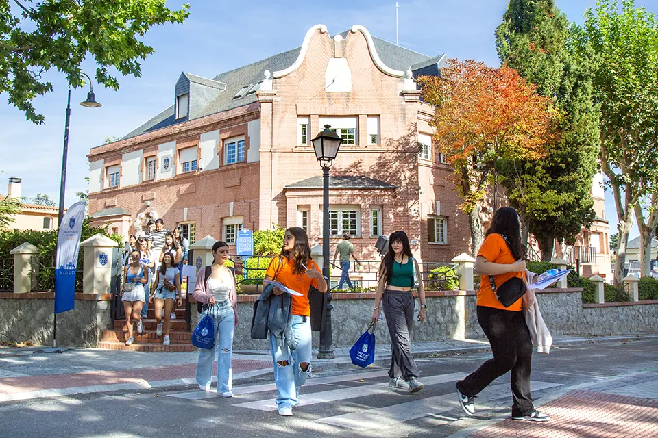 Students walking down the street in front of the SIH building.