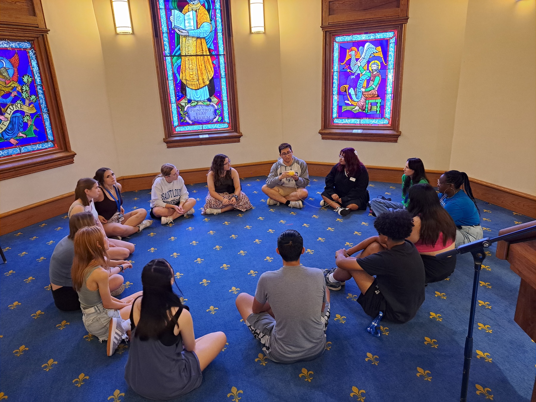 Micah students sit in a circle on the floor