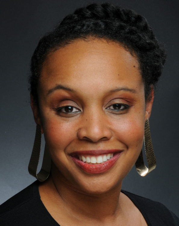 Artist-curator Lauren Kelley smile at the viewer in this close-up portrait.